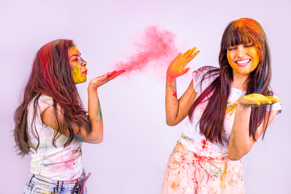 Girls enjoying and playing Holi